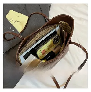 Interior view of spacious dark brown leather tote bag showing large storage capacity