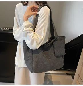Macro shot of dark grey tweed tote bag texture and matching detachable small pouch