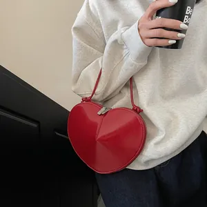 Chic red heart shaped crossbody bag in glossy PU leather with silver zipper and slim strap