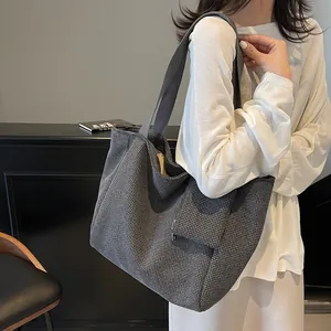 Chic houndstooth tote bag with grey shoulder straps and side pockets for women's daily use