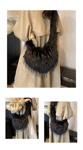Detailed side view of the black heart-shaped fluffy faux fur tote bag and furry shoulder strap