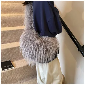 Detailed side view of a fluffy gray faux fur shoulder bag on a stylish model