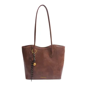 Minimalist dark brown leather tote bag with elegant straps and fashion logo print