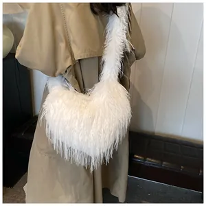 Detail of white faux fur heart-shaped shoulder bag with soft plush texture on autumn coat