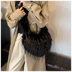 Detail of fluffy black plush crescent bag on shoulder over long brown trench coat
