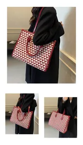 Macro view of red heart patterned tote bag showing fabric texture and shoulder strap detail