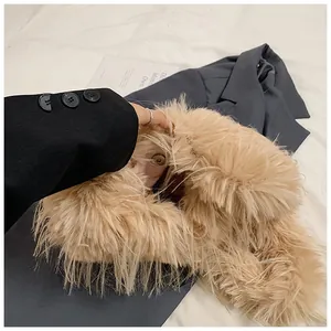 Detailed close-up of soft beige faux fox fur texture and inner magnetic snap closure