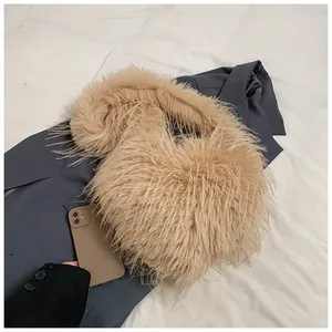 Close-up of camel fluffy heart-shaped tote bag showing soft long-plush texture and strap