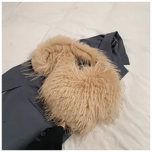 Detail of camel plush faux fur tote bag showing soft texture on a grey blazer