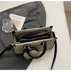 Detail view of khaki contrast tote bag with black handles and small round coin purse
