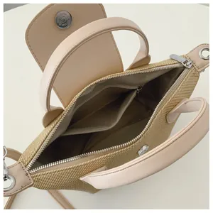 Detail view of beige woven bag showing interior zip pocket and magnetic clasp