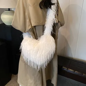 Furry white plush tote bag with long feather texture shown on a stylish trench coat
