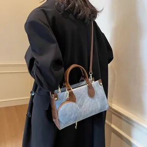 Blue denim and brown leather tote bag with matching round coin purse accessory