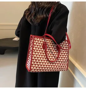 Detail of red and white heart pattern jacquard fabric on a large wedding tote bag