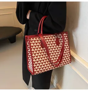 Macro detail of red and white heart jacquard pattern on a large wedding tote bag