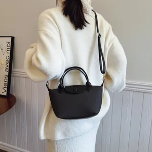 French retro black textured dumpling bag with top handle and adjustable strap for women