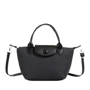 Chic dark grey woven crossbody bag with black leather flap and top handle details