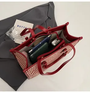 Detailed interior view of red houndstooth tote bag showing large capacity and inner pocket