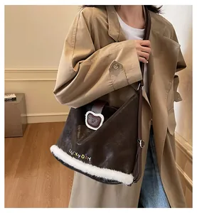 Detail of brown faux leather tote with white plush trim and Lucky Day embroidery
