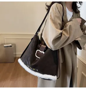 Detail of dark brown tote bag with white plush trim and Lucky Day embroidery on surface
