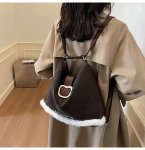 Detail of dark brown tote with white fur trim and Lucky Day bear patch on the back