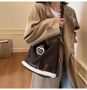 Detail of vintage brown tote bag with white faux fur trim and Lucky Day embroidery