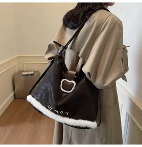 Detail of vintage brown leather bag with white plush trim and bear charm accent
