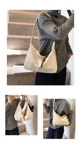 Detailed view of cream-white glossy leather bag with woven side pendant and shoulder strap