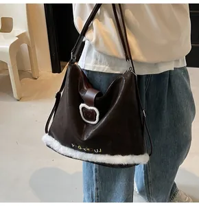 Detail of dark brown leather tote with plush bear buckle and LUCKY DAY embroidery