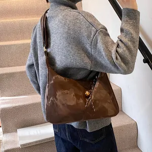 Chic brown leather hobo shoulder bag with golden buckle and woven knot detail