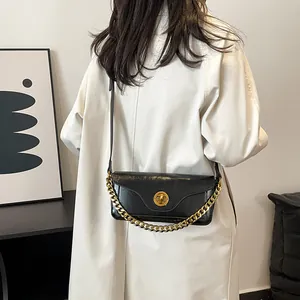 Retro black leather underarm bag with gold chain and metal lock for women in 2025 fashion