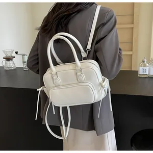 White leather minimalist backpack with silver hardware and drawstring side details
