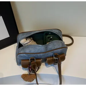 Internal view of blue denim Boston bag showing capacity for phone and umbrella