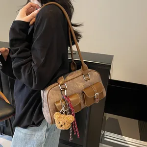 Retro brown Boston bag with small front flap pockets and plush bear charm decoration