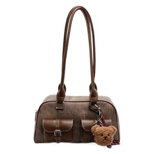 Retro brown Boston shoulder bag with plush bear keychain and matte faux leather texture