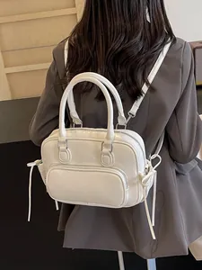 Minimalist white leather backpack with bow drawstrings worn by a model in casual style
