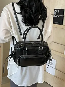 Minimalist black PU leather backpack for women with shiny vintage finish and zip pockets