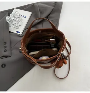 Top view of brown leather bucket bag interior showing spacious compartments and accessories