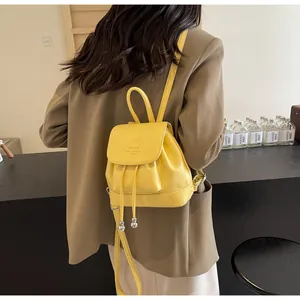 Detail of yellow lychee grain PU leather backpack with drawstring and logo