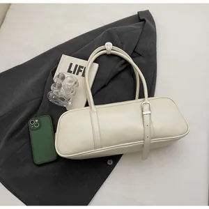 Detailed top view of off-white baguette shoulder bag with smooth leather and silver buckle