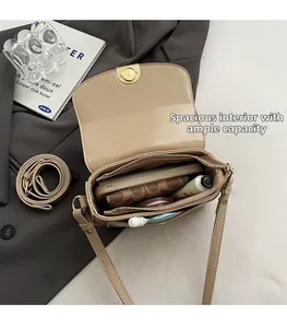 Detail of beige crocodile pattern saddle bag interior with large capacity and zip pocket