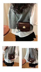Close-up of retro crocodile pattern leather saddle bag with gold buckle and horse charm