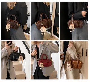 Detail showing the ZSKE BAGS glossy PU leather finish and cute plush sheep charm
