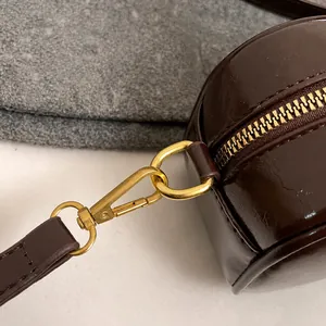 Detail of high-quality golden metal hook and hardware on retro brown PU leather square bag