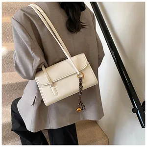 Chic cream white leather shoulder bag with gold hardware and silk scarf detail