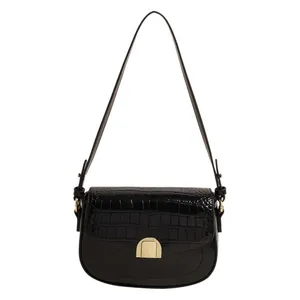 Retro black crocodile embossed saddle bag with gold hardware and smooth leather finish