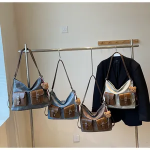 Close-up of four large capacity tote bags in grey, blue, coffee, and beige with bear charm