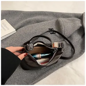 Detail view of the vintage dumpling bag showing interior space and silver metal buckle