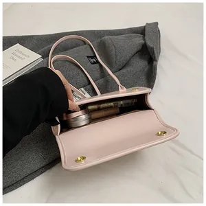 Interior detail of pink leather underarm bag showing spacious storage for cosmetics