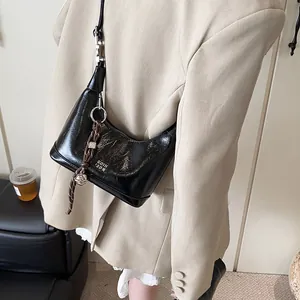 Vintage black shiny leather hobo shoulder bag with unique braided rope charm detail